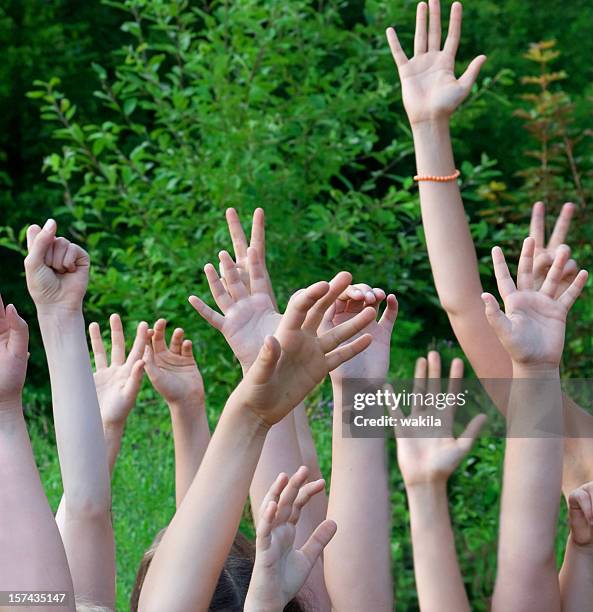 many children hands in the air want more atention - child palm of hand stock pictures, royalty-free photos & images