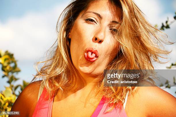 girl curling tongue - tongue stock pictures, royalty-free photos & images