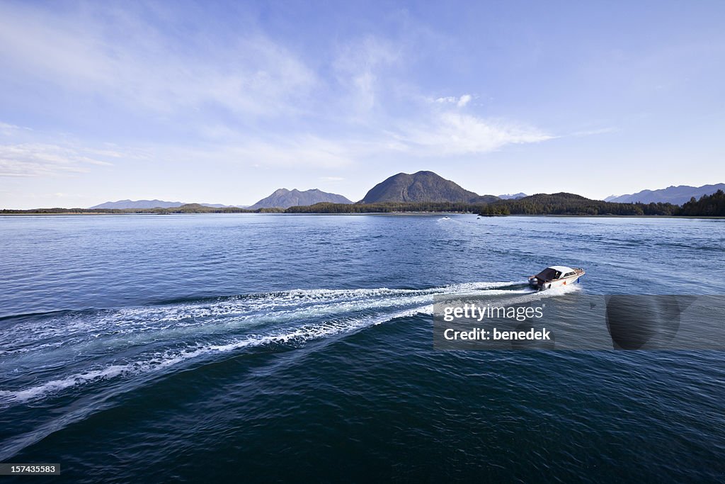 Ocean Shore with motorboat speeding away
