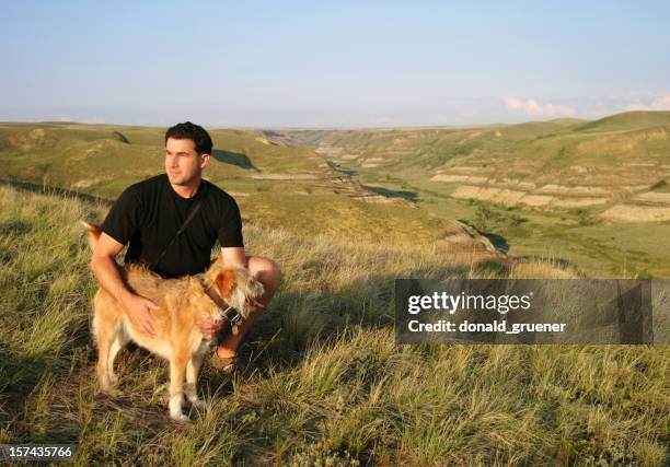 hiker with dog enjoying view - alberta badlands stock pictures, royalty-free photos & images