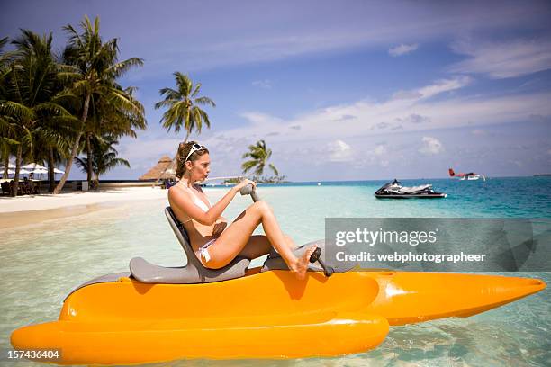 woman in paddle boat - paddleboat stock pictures, royalty-free photos & images