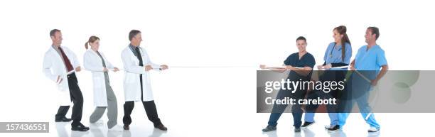 medical tug of war - tug of war stock pictures, royalty-free photos & images