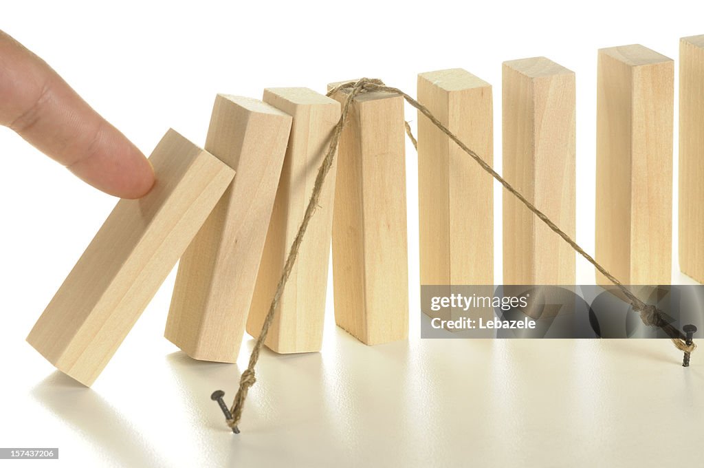 Illustration using tethered wooden dominos for insurance