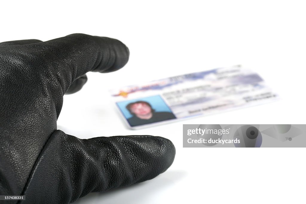 Identity Thief's Hand Reaching for I.D.