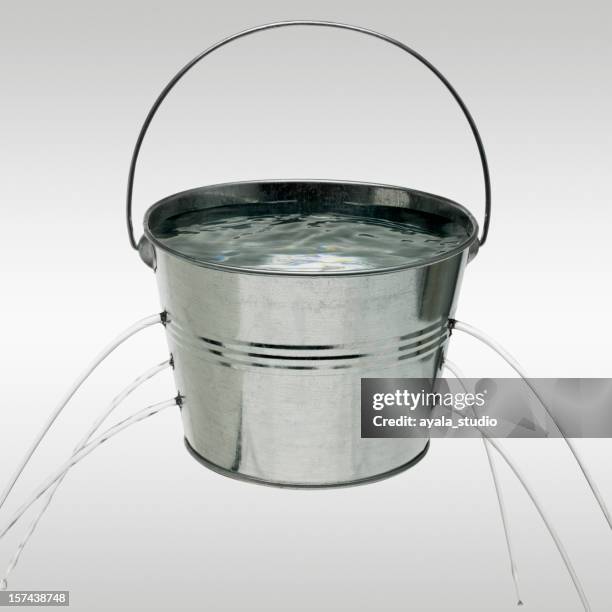 water leaking from holes in bucket - emmer stockfoto's en -beelden