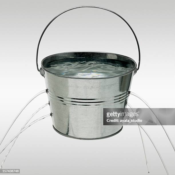 water leaking from holes in bucket - bucket stock pictures, royalty-free photos & images