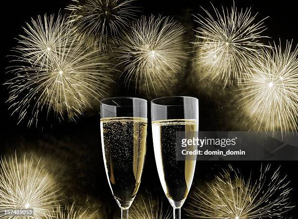 two glasses of champagne, new year's day fireworks display - champagne popping stock pictures, royalty-free photos & images