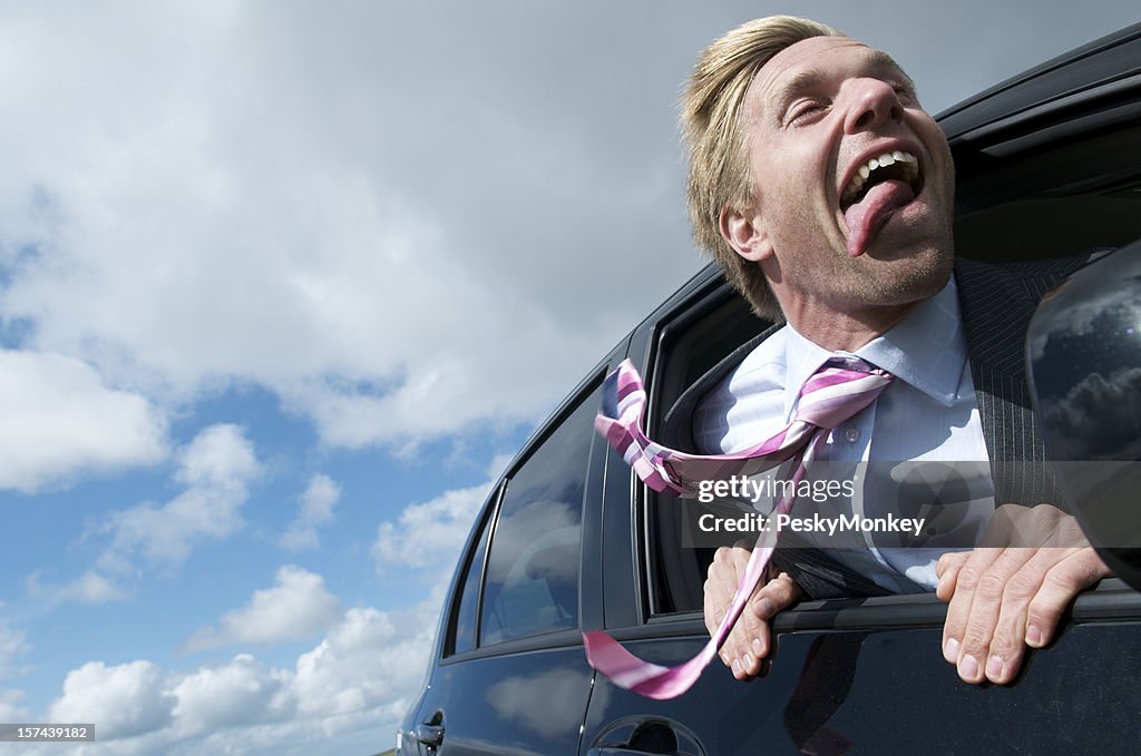 Excited Businessman Leans His Head out the Car Window