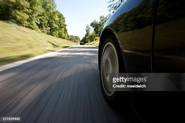 outside view of a car driving down the street - car back stock pictures, royalty-free photos & images