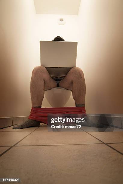 computer addiction - man in bathroom sitting on toilet stock pictures, royalty-free photos & images