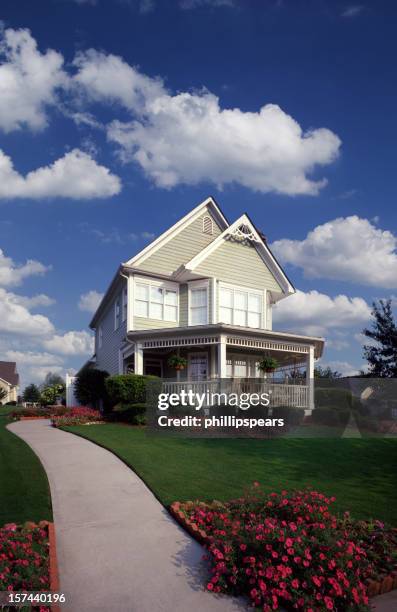 suburban home with garden and fluffy clouds - model home exterior stock pictures, royalty-free photos & images