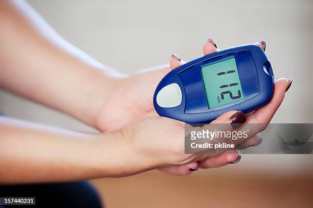 testing blood sugar at home - altitude sickness stock pictures, royalty-free photos & images
