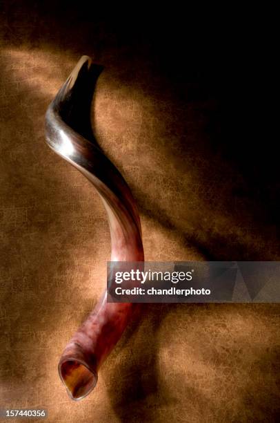 shofar with shadow, brown background and a glow of light. - shofar stock pictures, royalty-free photos & images