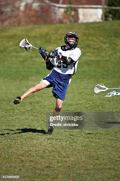 male lacrosse player jumps into a shot on goal - lacrosse 個照片及圖片檔