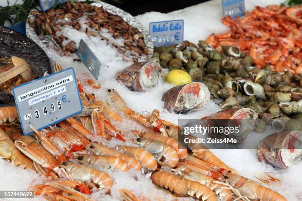 fresh seafood on display in market - fish market stock pictures, royalty-free photos & images