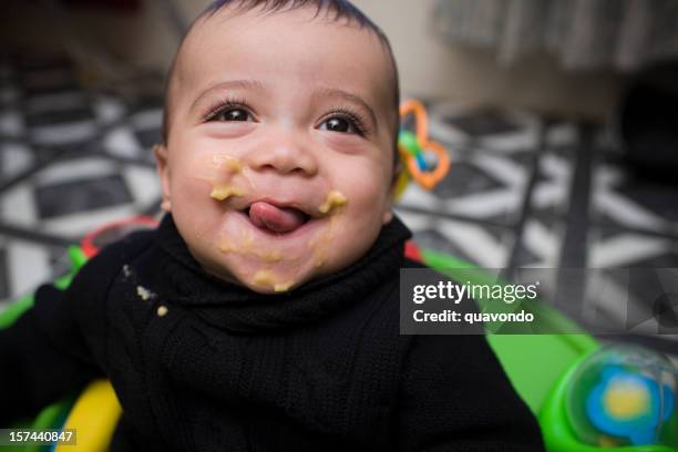 adorable hispanic baby boy eating in high chair, copy space - baby eating stock pictures, royalty-free photos & images