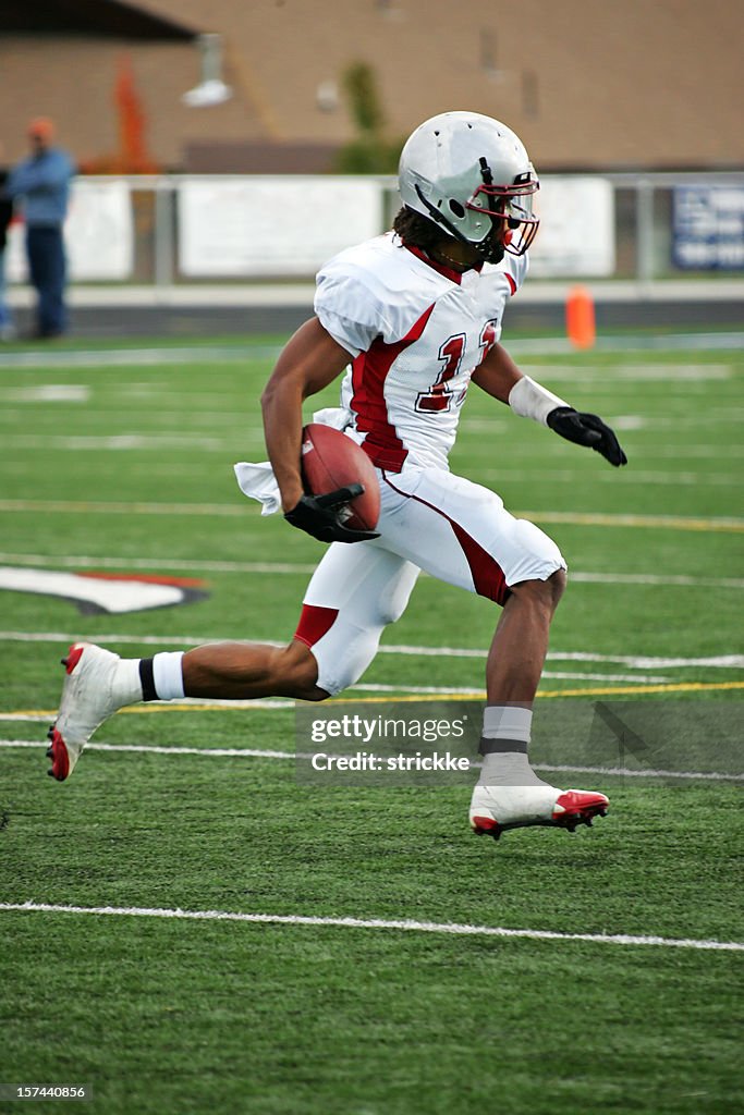 American Footbal Player in Flying Sprint after Pass Reception