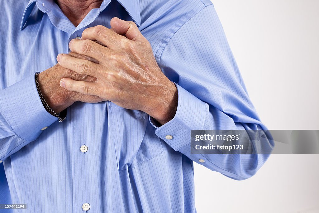 Man clutching his chest. in pain, possible heart attack