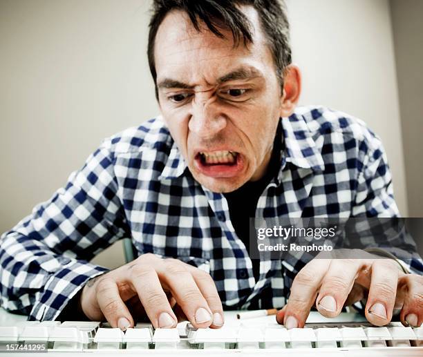 man typing a complaint through email - angry typing stock pictures, royalty-free photos & images