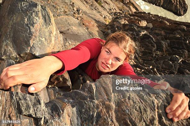 a female free climbing up the side of a mountain  - free climbing stock pictures, royalty-free photos & images