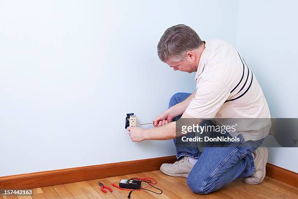 electrician working - wall outlet stock pictures, royalty-free photos & images