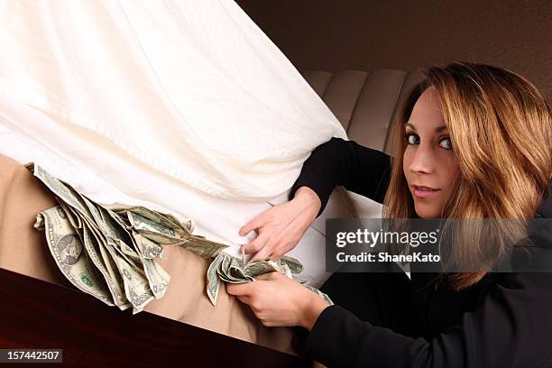 hiding your money under a mattress - hiding money stock pictures, royalty-free photos & images