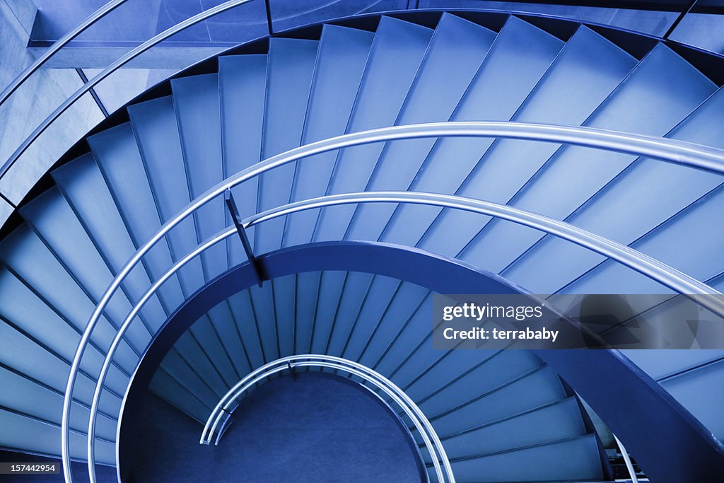 A blue spiral staircase seen from above