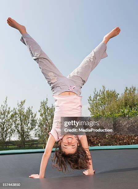 girl jumping on trampoline - doing the splits stock pictures, royalty-free photos & images