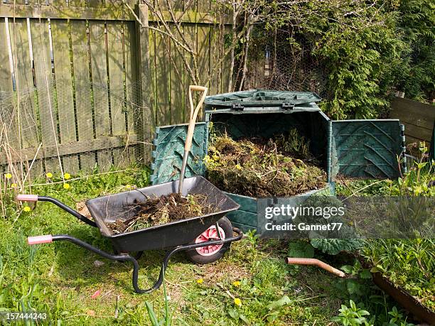 garden compost bin and wheelbarrow - compost bin stock pictures, royalty-free photos & images