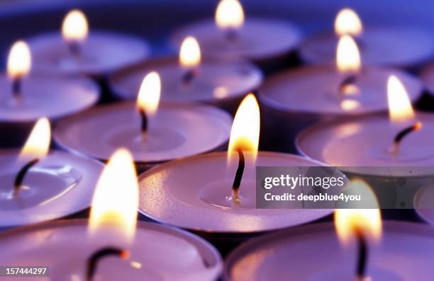 burning violett candles background - candlelight stock pictures, royalty-free photos & images