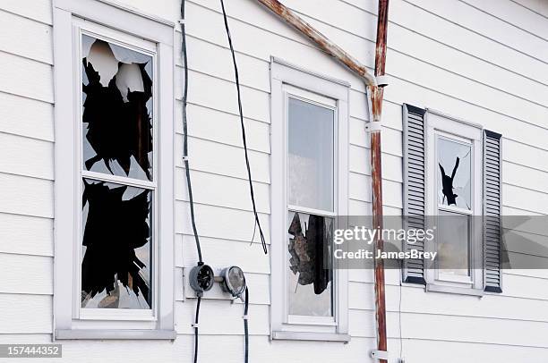 broken windows; vandalism, disaster, wind or earth quake damage - vandalisme stockfoto's en -beelden