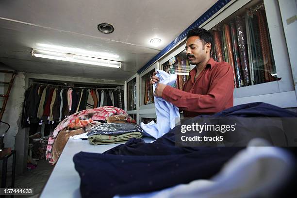 indian workers: laundry - indian shopkeeper stock pictures, royalty-free photos & images