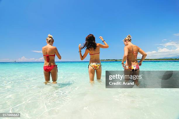 girls on beach - three girls at beach stock pictures, royalty-free photos & images