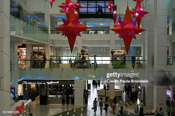 Shoppers browse inside the Junction Square shopping mall on November 30, 2012 in downtown Yangon, Myanmar. Business opportunities are expanding in...