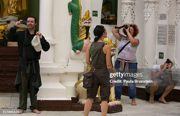 Tourists take a photo at the Shwedagon pagoda on November 30, 2012 in downtown Yangon, Myanmar. Business opportunities are expanding in the Southeast...