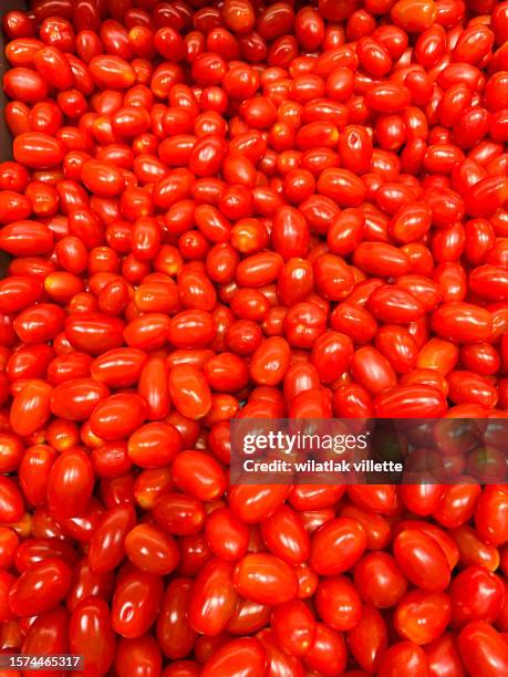 red tomatoes background. group of tomatoes close-up - cherry tomato stock pictures, royalty-free photos & images