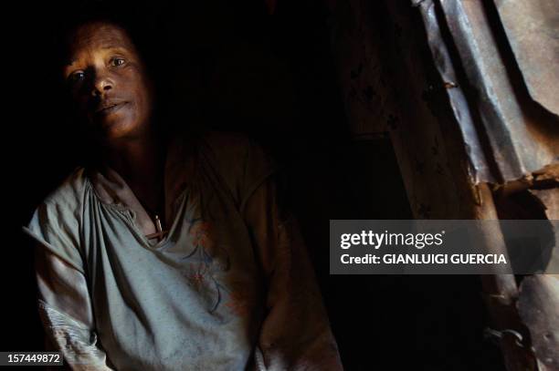 An HIV positive Ethiopian woman rests, 27 May 2005, in her hut after she has been given free antiretroviral that she periodically receives for her...