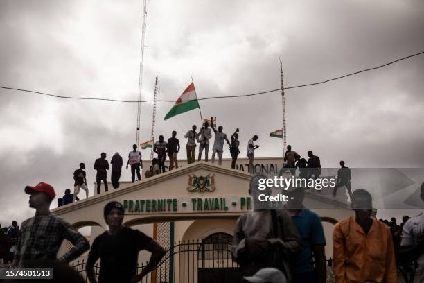 Protesters hold a Niger flag during a demonstration on independence day in Niamey on August 3, 2023. Hundreds of people backing the coup in Niger...