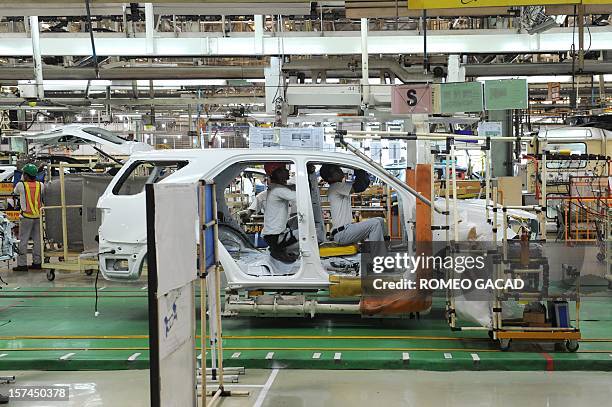 Indonesian workers inspect shells of Toyota vehicles at the assembly line of Toyota Motor's Indonesian unit, Toyota Motor Manufacturing Indonesia...