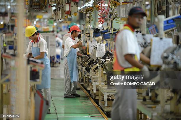 Indonesian workers work the assembly line of Toyota Motor's Indonesian unit, Toyota Motor Manufacturing Indonesia plant in Karawang industrial center...