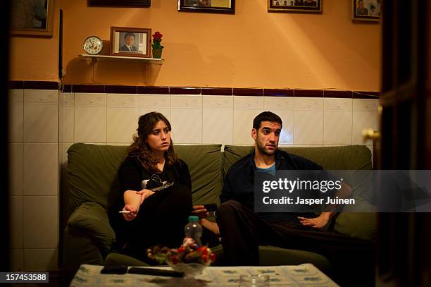 Unemployed twenty-year old Maria Regina Fernandez spends the night watching television with her boyfriend, who does also not hold a job, instead of...