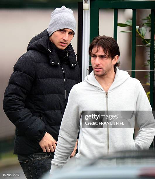 Paris Saint-Germain's Swedish forward Zlatan Ibrahimovic and Brazilian defender Maxwell leave the PSG football club training center in...