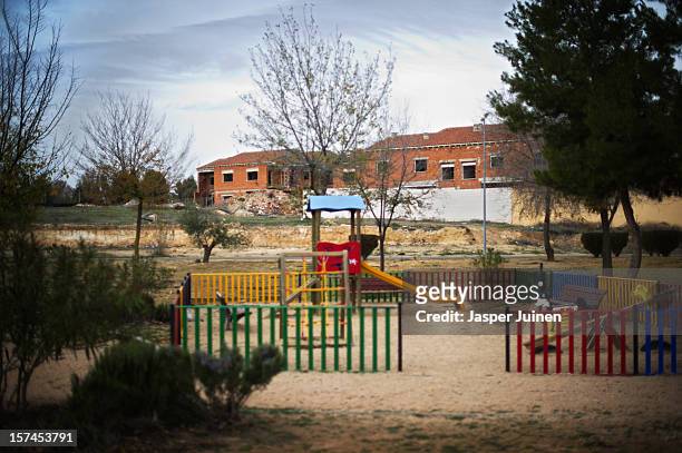 Playground for children stands backdropped by unfinished homes on November 30, 2012 in Villacanas, Spain. During the boom years, where in its peak...