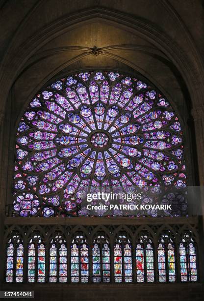 View of the middle-age stained glass rosace on the northern side of the Notre-Dame de Paris cathedral, on November 29 in Paris. AFP PHOTO / PATRICK...