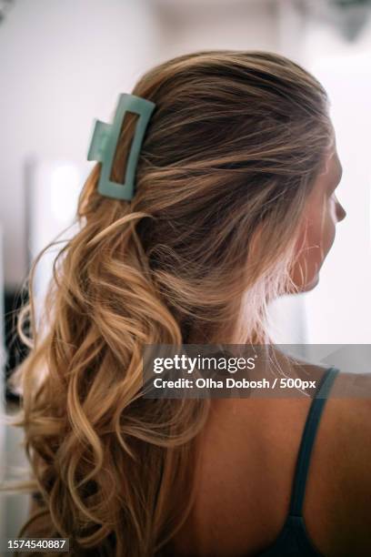 rear view of woman with beautiful blonde hair standing against wall,spain - haarspange stock-fotos und bilder