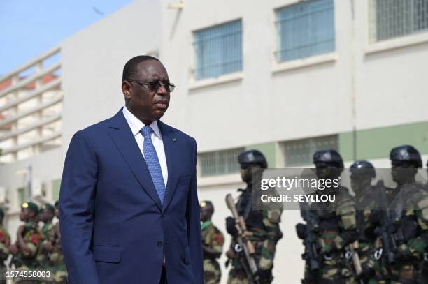 Senegal President Macky Sall reviews the troops as he arrives for the unveiling of the OPV 58S 'Walo' vessel in the quay of the naval base in Dakar...