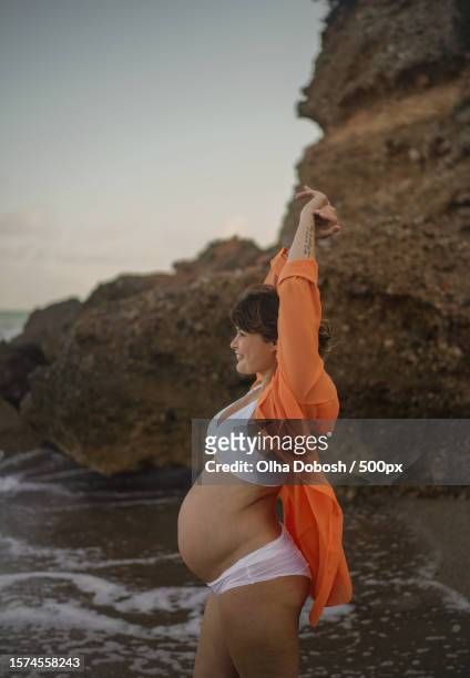 pregnant woman enjoys evening seaside,tarragona,spain - woman swimsuit happy normal stock pictures, royalty-free photos & images