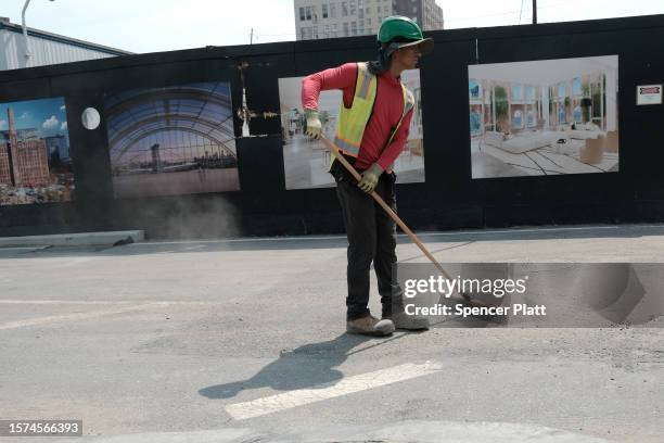 Man works in the sun at a construction site during a heat wave on July 27, 2023 in the Brooklyn borough of New York City. New York City and much of...