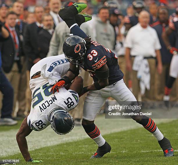 Charles Tillman of the Chicago Bears upends Anthony McCoy of the Seattle Seahawks at Soldier Field on December 2, 2012 in Chicago, Illinois. The...