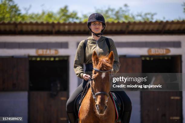 woman riding a horse - recreational horseback riding stock pictures, royalty-free photos & images